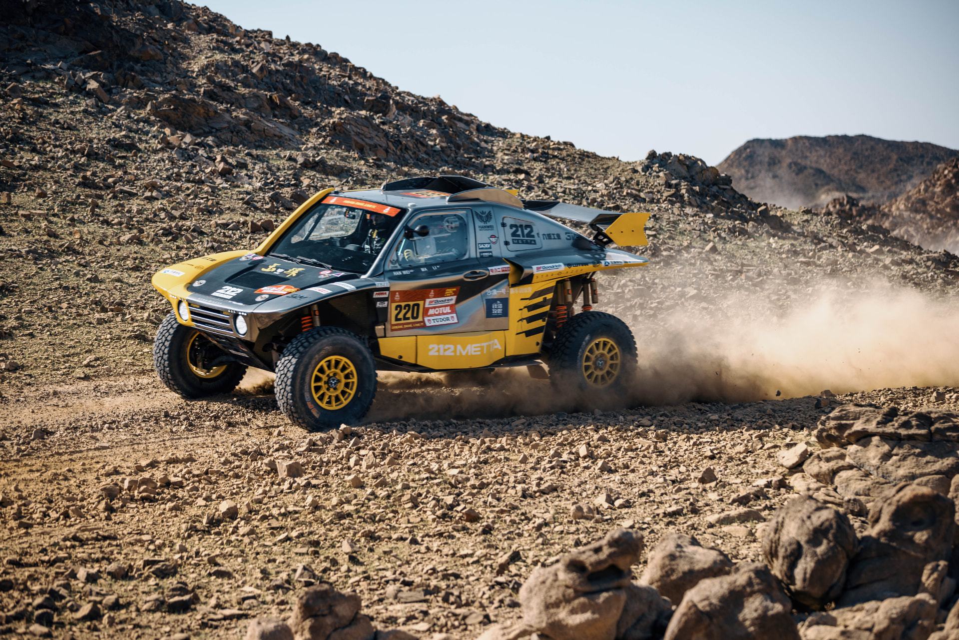 HWM T1+ race car number 220 crossing rough rocky terrain