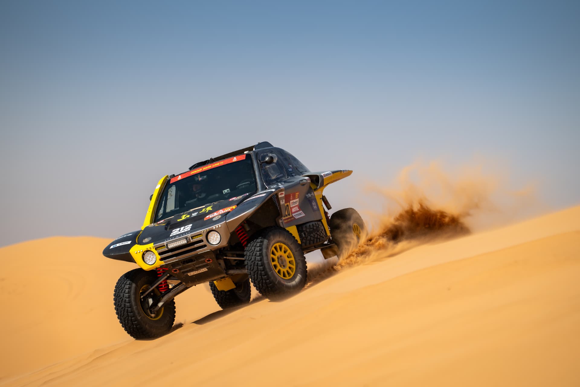HWM T1+ race car number 220 descending a sand dune